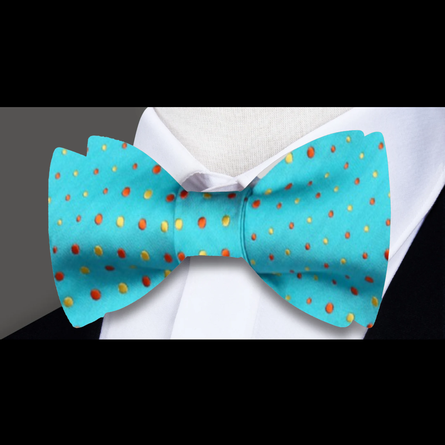 A Light Blue, Yellow, Orange Polka Pattern Self Tie Bow Tie