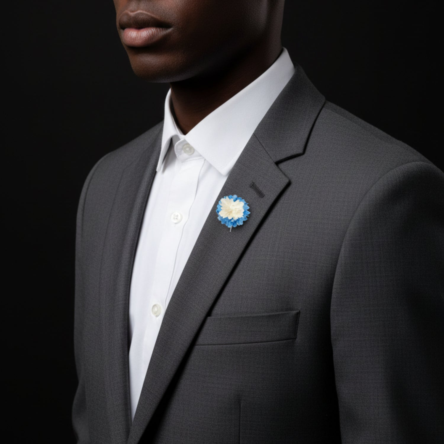 Blue and white flower brooch on man
