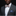 Man wearing a gray suit with a patterned bow tie and pocket square on a black background
