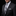 Man wearing a black suit with a patterned tie and pocket square on a black background