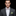 Man wearing pink and green paisley bow tie and accenting square