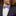 Man wearing suit with purple and yellow stripe bow tie and purple square