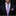Man wearing a black suit with a pink and blue patterned tie and pocket square.