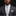Man wearing a gray suit with a striped tie and pocket square on a black background