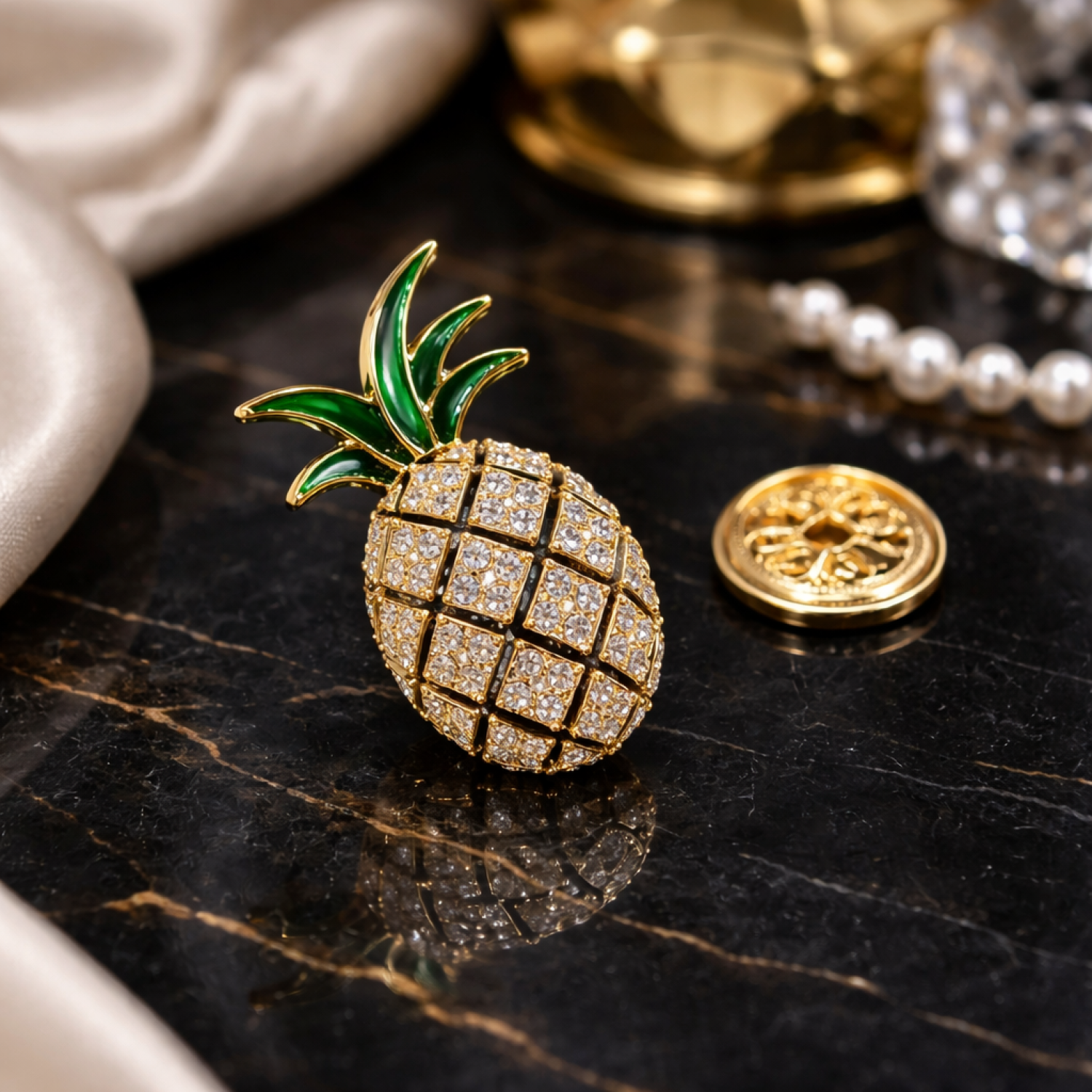 Gold pineapple-shaped brooch with green top on a dark surface