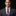 Man wearing a gray suit with a A Purple, Cream, Blue Plaid Pattern Necktie and Square
