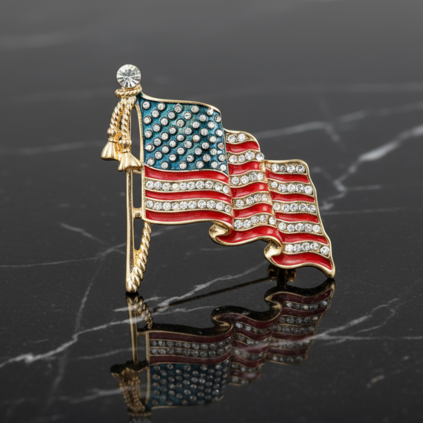 American flag brooch with rhinestones on a dark marble background