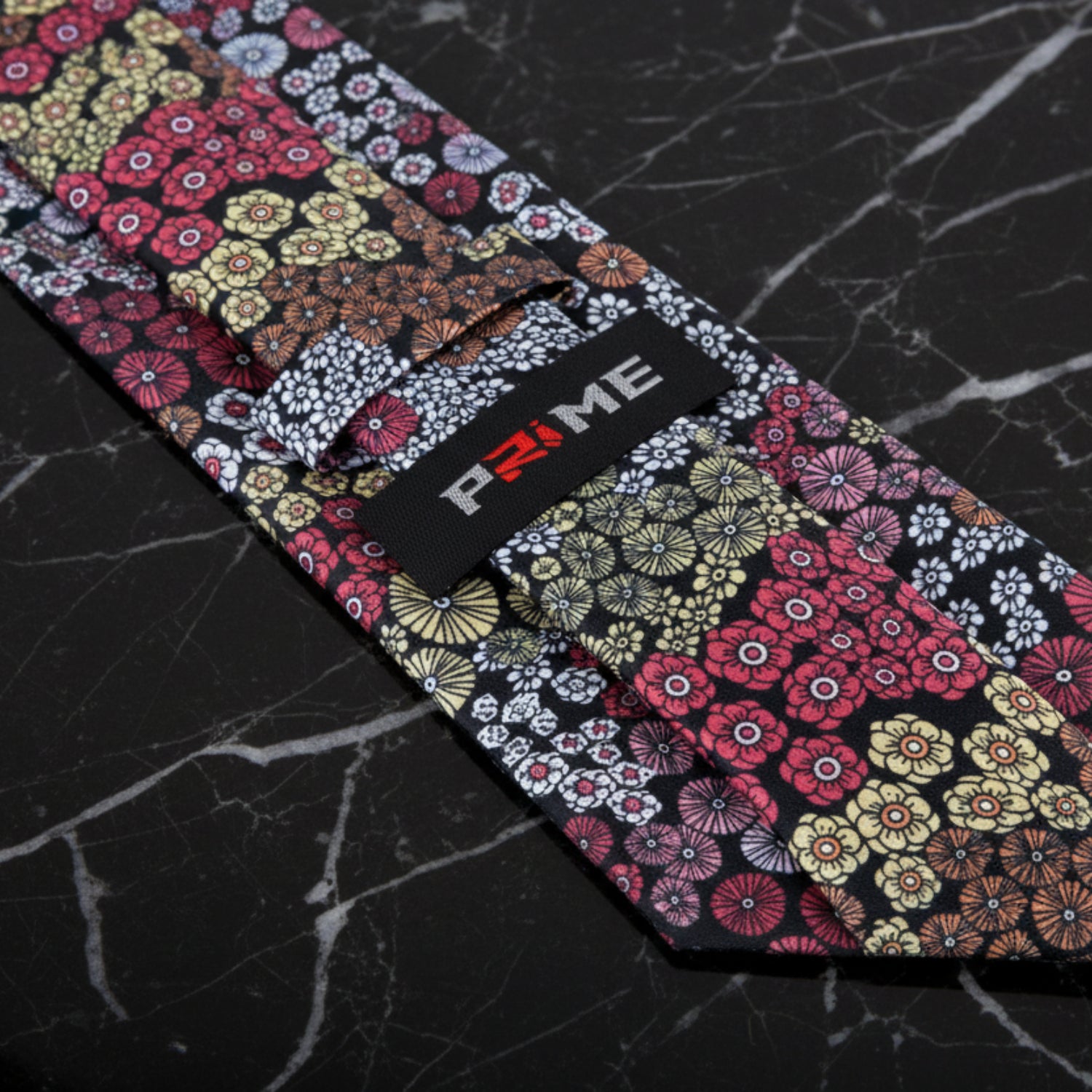 Floral-patterned product with branding on a dark marble surface