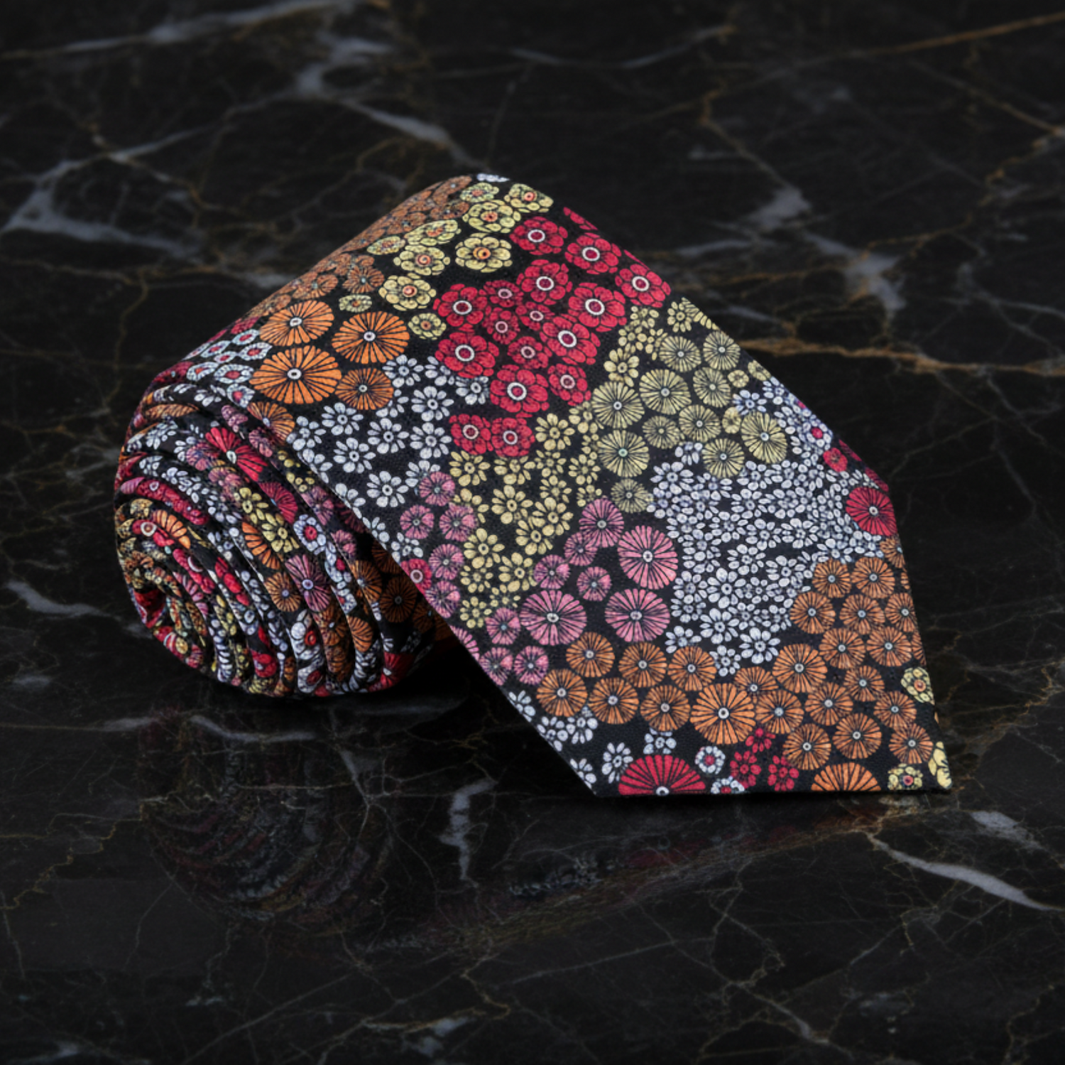 Floral patterned tie on a dark marble surface