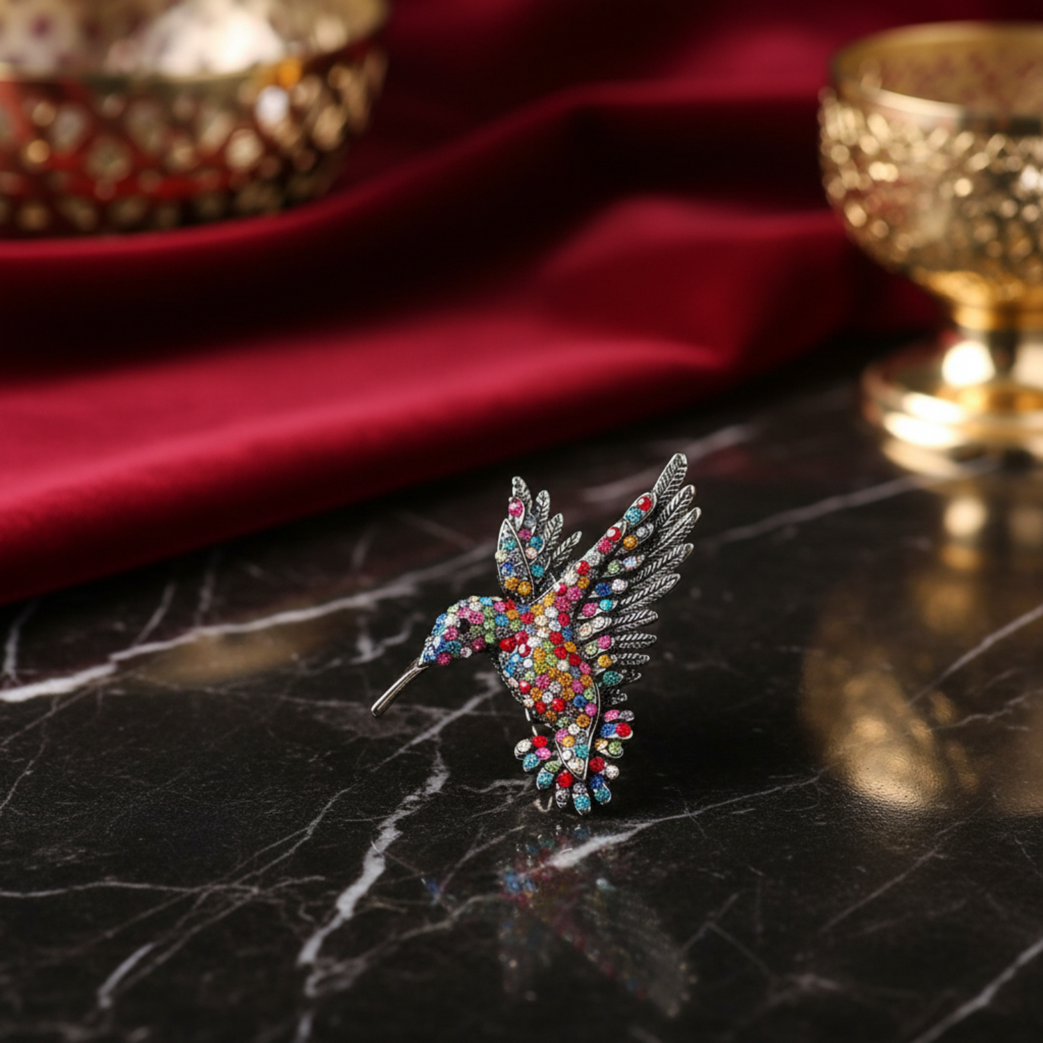 Colorful gemstone hummingbird brooch on a white background