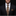 Man wearing a black suit with a patterned tie and pocket square on a dark background
