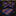 A bow tie with brownish orange and blue block stripes placed on a wooden surface with green leaves in the background.