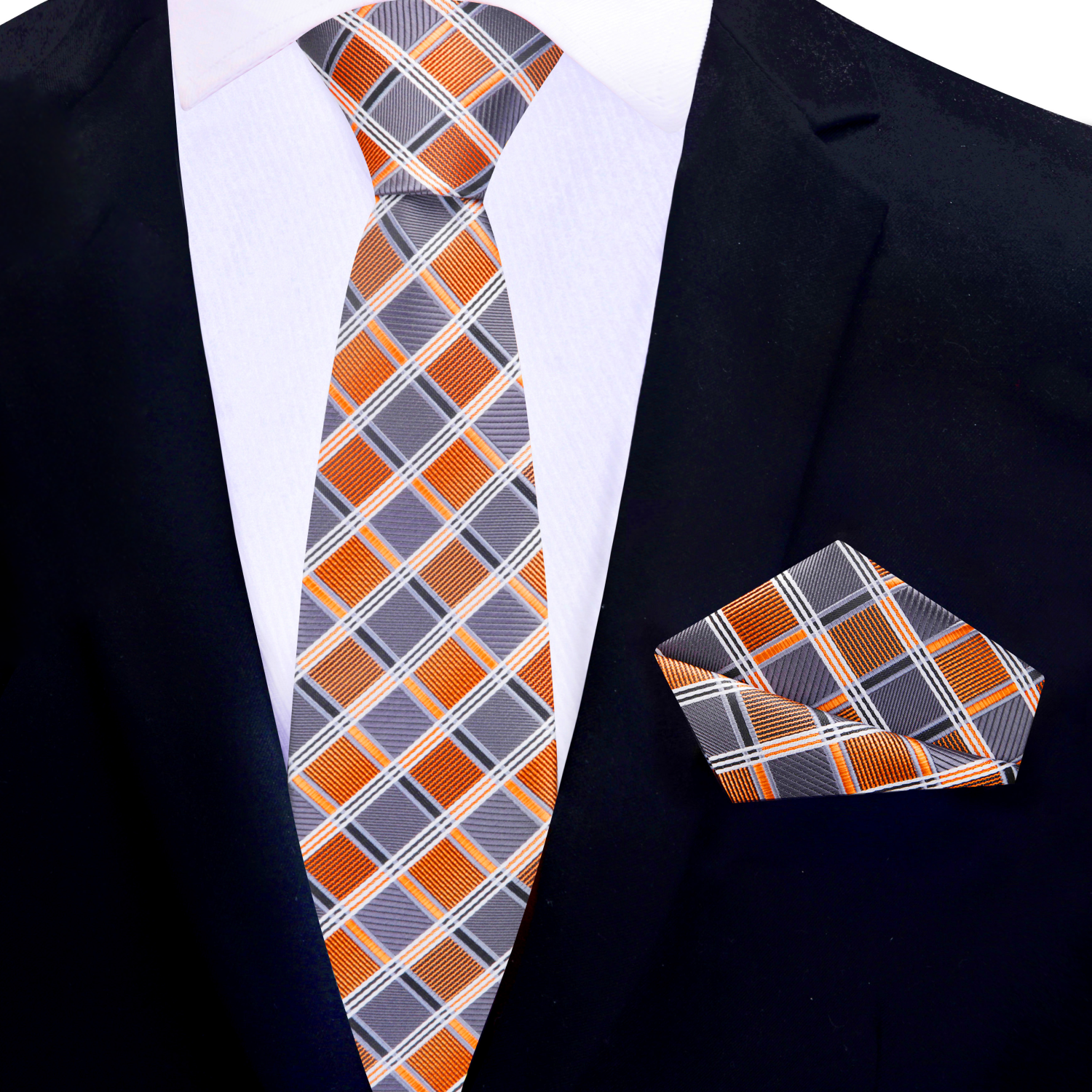 Orange and grey plaid thin tie and matching pocket square on a black suit jacket.