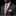 Man wearing a dark suit with a orange and grey patterned tie and white shirt against a black background