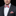 Man wearing a colorful bow tie and matching pocket square with a black suit.