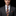 Man wearing a gray suit with a colorful tie and pocket square against a black background