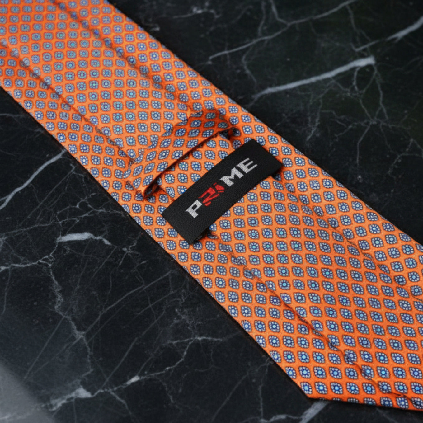 Tie Keep View: A Necktie that is sunfire coral with a small medallion pattern 