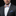 Man wearing a gray suit with a colorful blue, orange stripe bow tie and pocket square on a black background