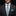 Man wearing a dark suit with a colorful tie and teal pocket square on a black background