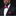Man wearing a black suit with a pink polka dot bow tie and pocket square on a black background