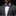 Man wearing a gray suit with a white shirt, purple bow tie, and matching pocket square on a black background.