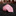 A rolled pink necktie with a floral and leaf pattern in shades of pink, peach, and white, displayed on a black marble surface with a blurred retail store background.