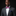 Man wearing a gray suit with a pink bow tie and pocket square on a black background