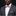 Man wearing a gray suit with a floral pink bow tie and matching pocket square on a black background