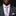 Man wearing a gray suit with a pink and blue striped tie and pocket square on a black background