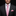 Man wearing a black suit with a pink polka dot tie and pocket square on a dark background