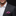 Man wearing a dark gray suit with a white shirt and purple paisley pocket square.