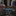 Two round black and silver media player icons with blue play buttons, shown side by side on a light gray background.