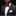 Man wearing a dark suit with a patterned bow tie and pocket square on a black background