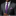 Man wearing a gray suit with a purple tie and pocket square on a black background