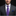 Man wearing a gray suit with a purple floral tie and blue pocket square on a black background