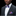 Man wearing a dark gray suit with a colorful bow tie and pocket square on a black background