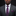 Man wearing a gray suit with a purple paisley tie and pocket square on a black background