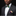 Man wearing a black suit with a colorful bow tie and matching pocket square on a black background