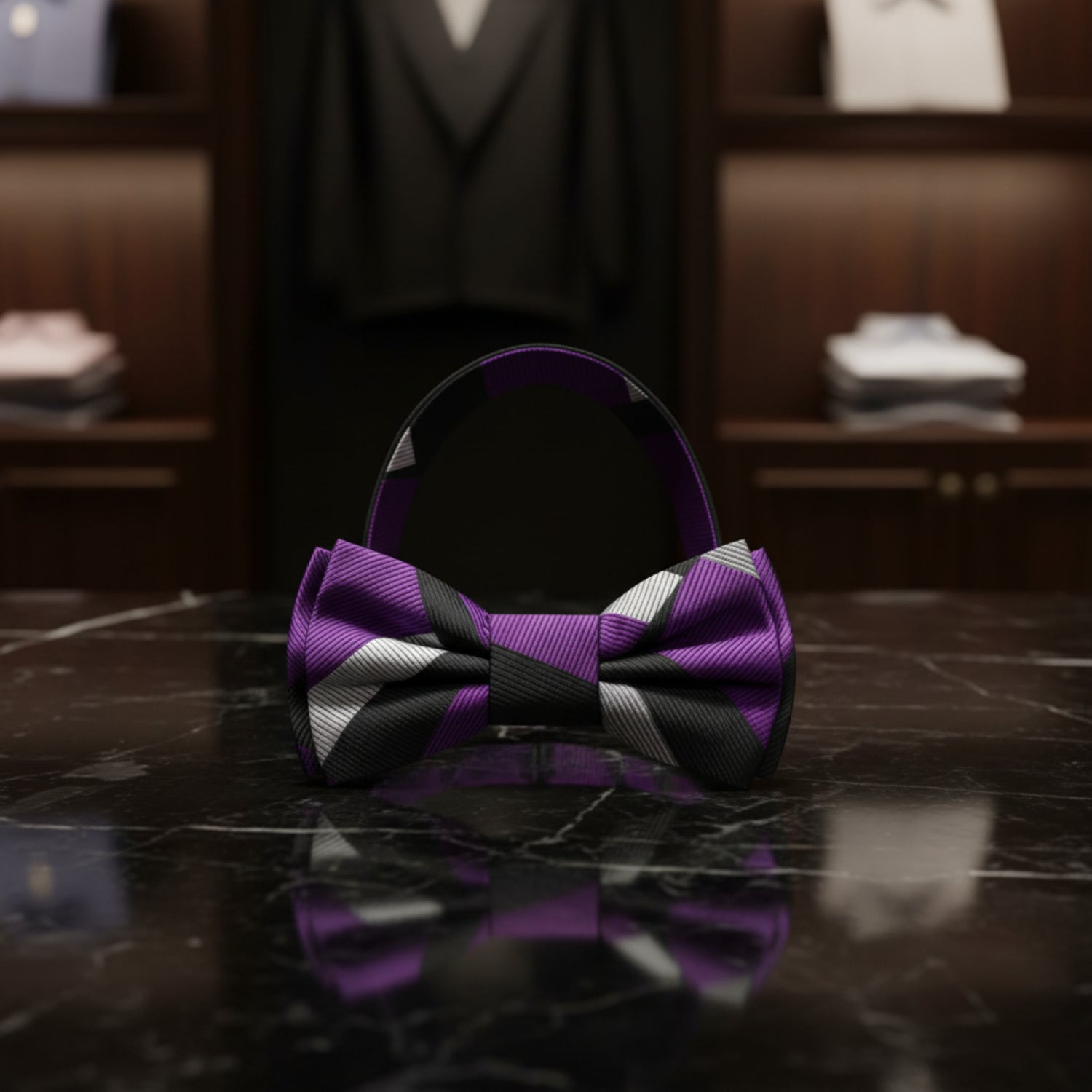 Purple, black, and gray striped bow tie on a white background