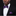 Man wearing a black suit with a purple and pink woven bow tie and pocket square against a dark background