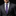 Man wearing a gray suit with a purple tie and pocket square on a black background