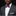 Man wearing a gray suit with a white shirt and colorful striped bow tie on a black background