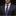 Man wearing a dark suit with a purple paisley tie and pocket square on a black background