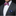 Man wearing a gray suit with a pink and white patterned bow tie and a blue pocket square.