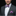 Man wearing pink purple and green bow tie and square with a floral pattern 