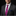 Man wearing a dark suit with a pink floral tie and blue pocket square on a black background