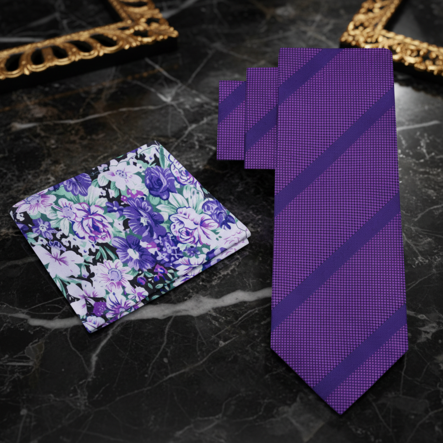 Set of purple floral pocket square and striped tie on marble