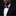 Man wearing a black suit with a purple bow tie and pocket square on a dark background