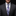 Man wearing a dark gray suit with a white shirt and plaid tie on a black background