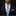 Man wearing a black suit with a floral tie and pocket square on a dark background